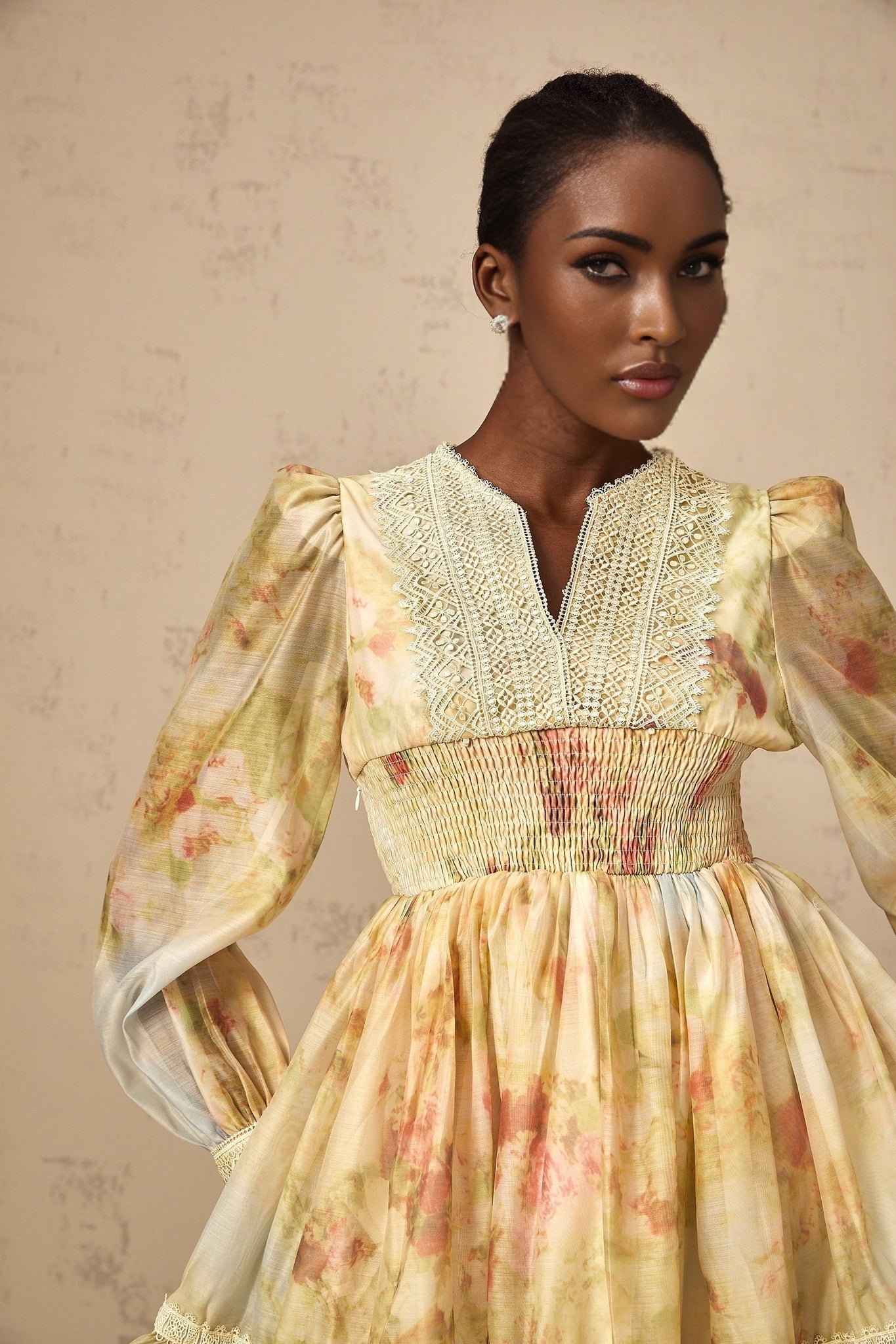 A yellow mini dress with floral print and lace panels named Olivia