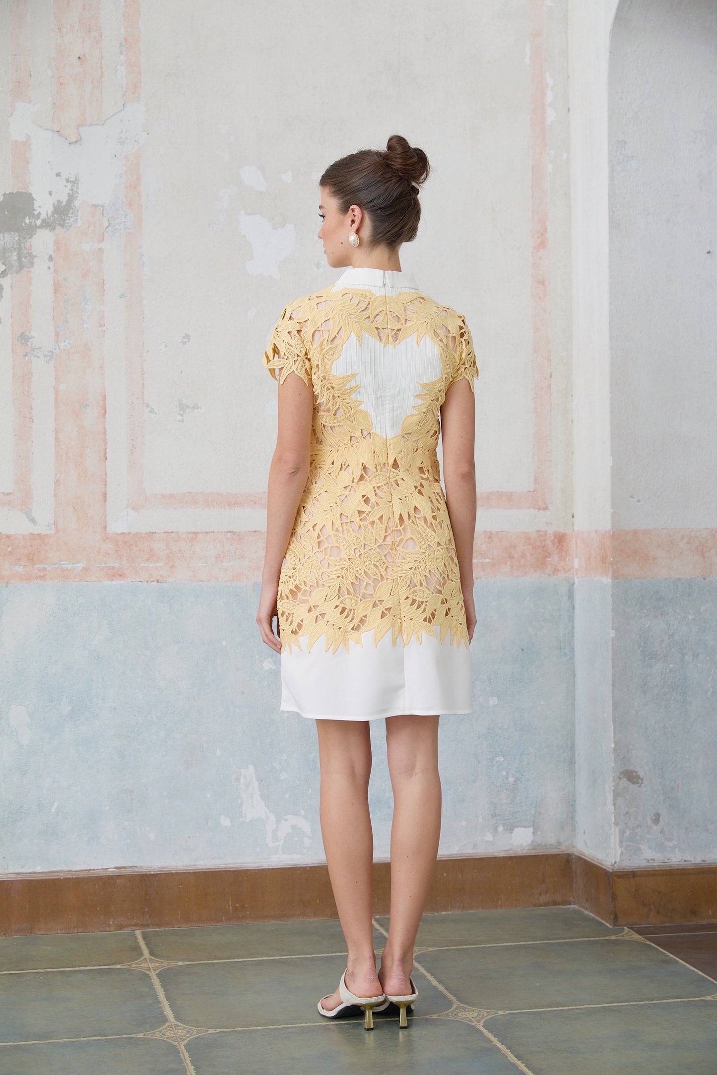A yellow mini dress with leaf appliques decorating the fabric Camille style short and vibrant summer dress