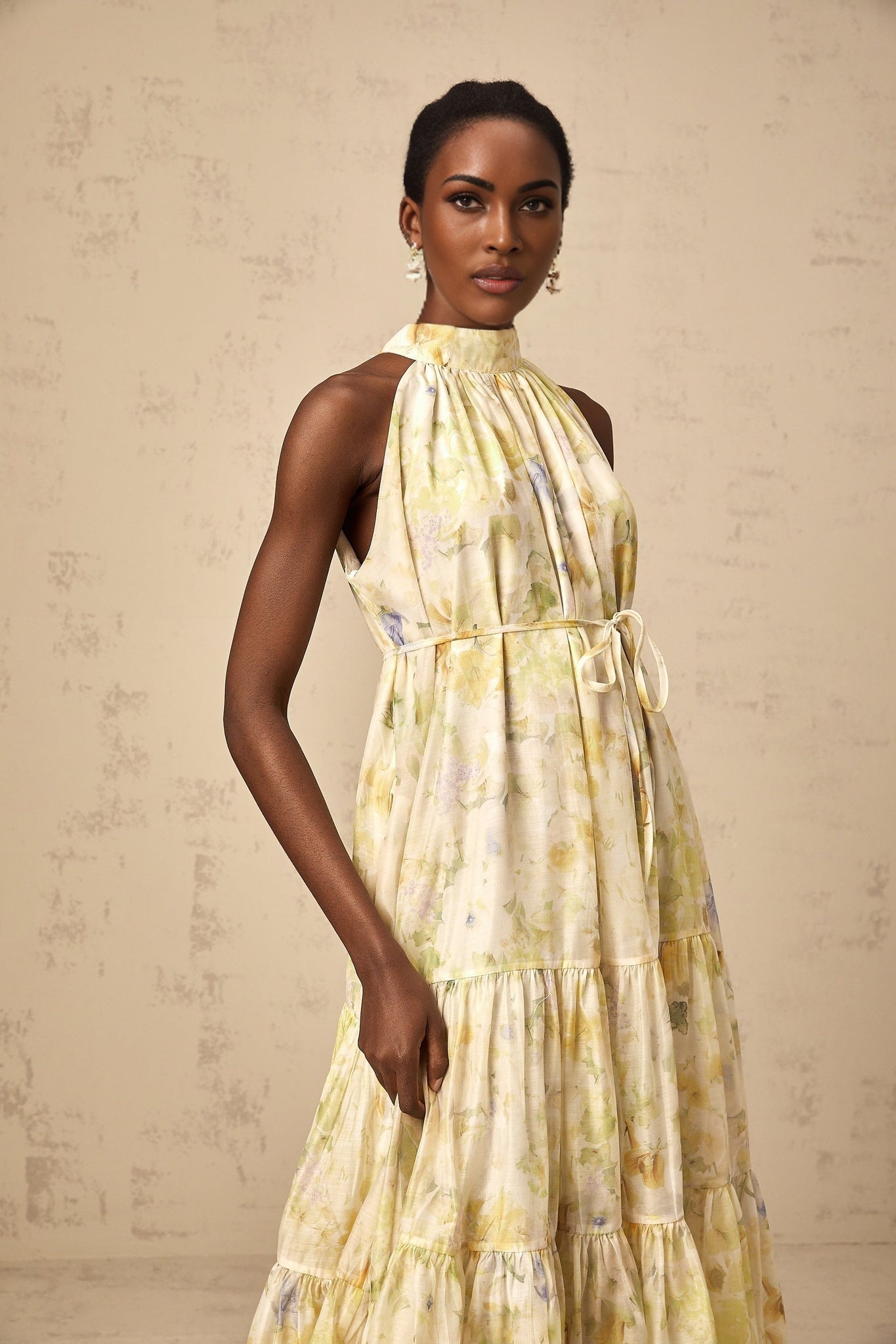 A yellow sleeveless midi dress with a floral print pattern named Ulani