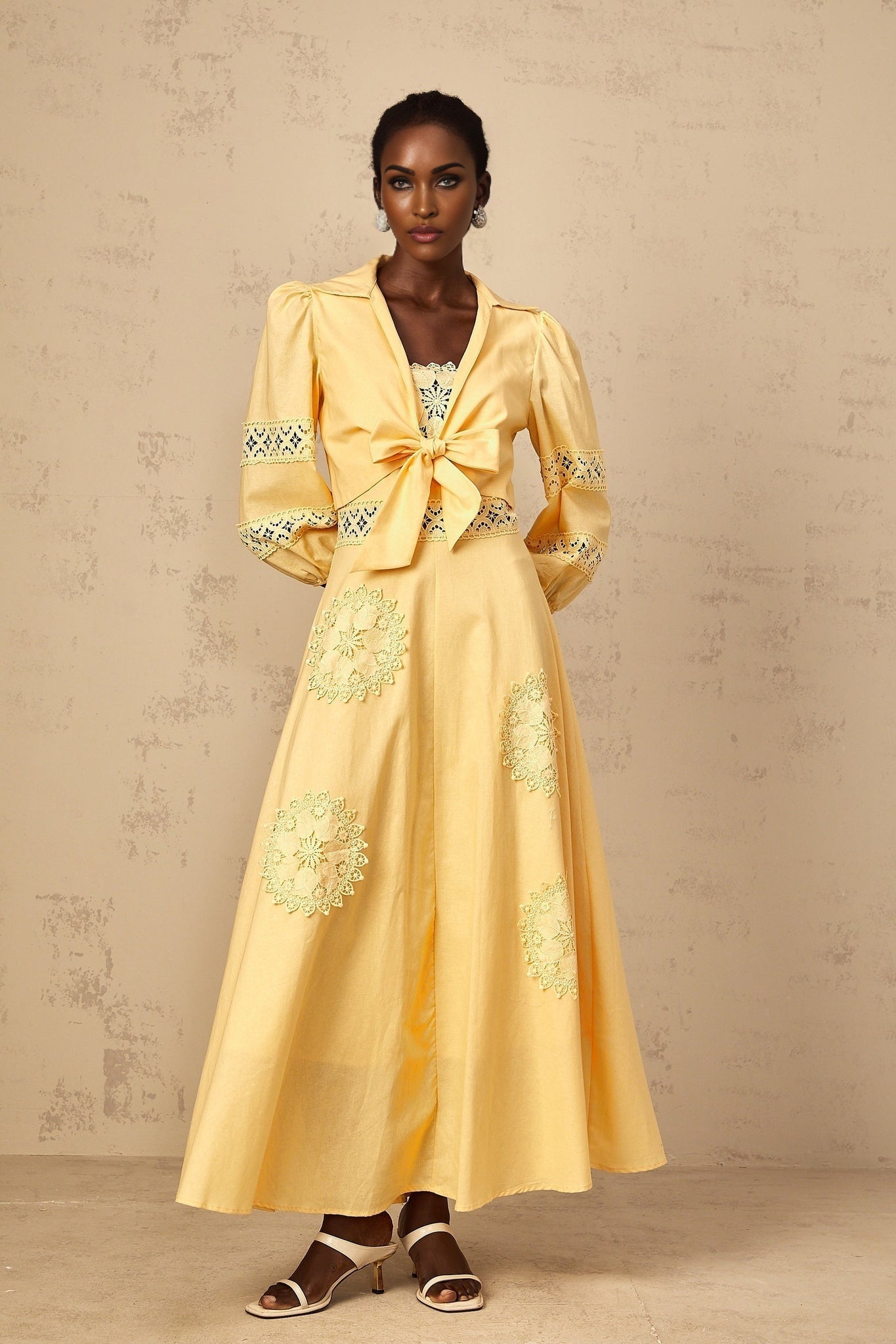 A young girl wearing a yellow blouse and dress set with delicate floral embroidery The blouse features short puff sleeves while the dress has a full skirt The outfit is bright and cheerful perfect for spring or summer
