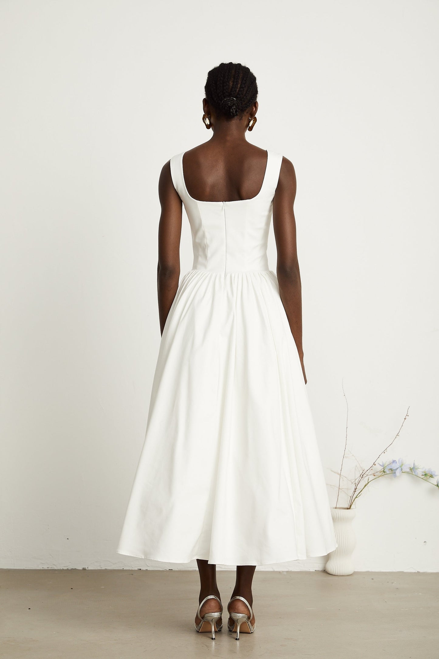 Alt text White pleated corset dress named Sadie with fitted bodice and flared skirt