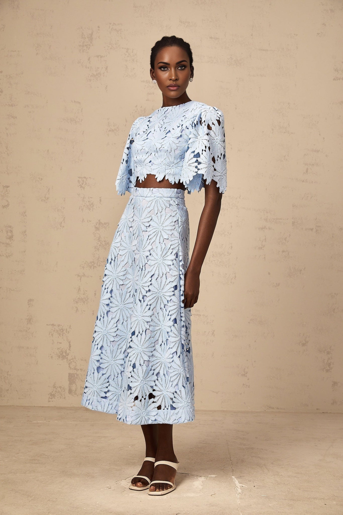 Audrey blue matching set with guipure lace top and skirt worn by model on plain background