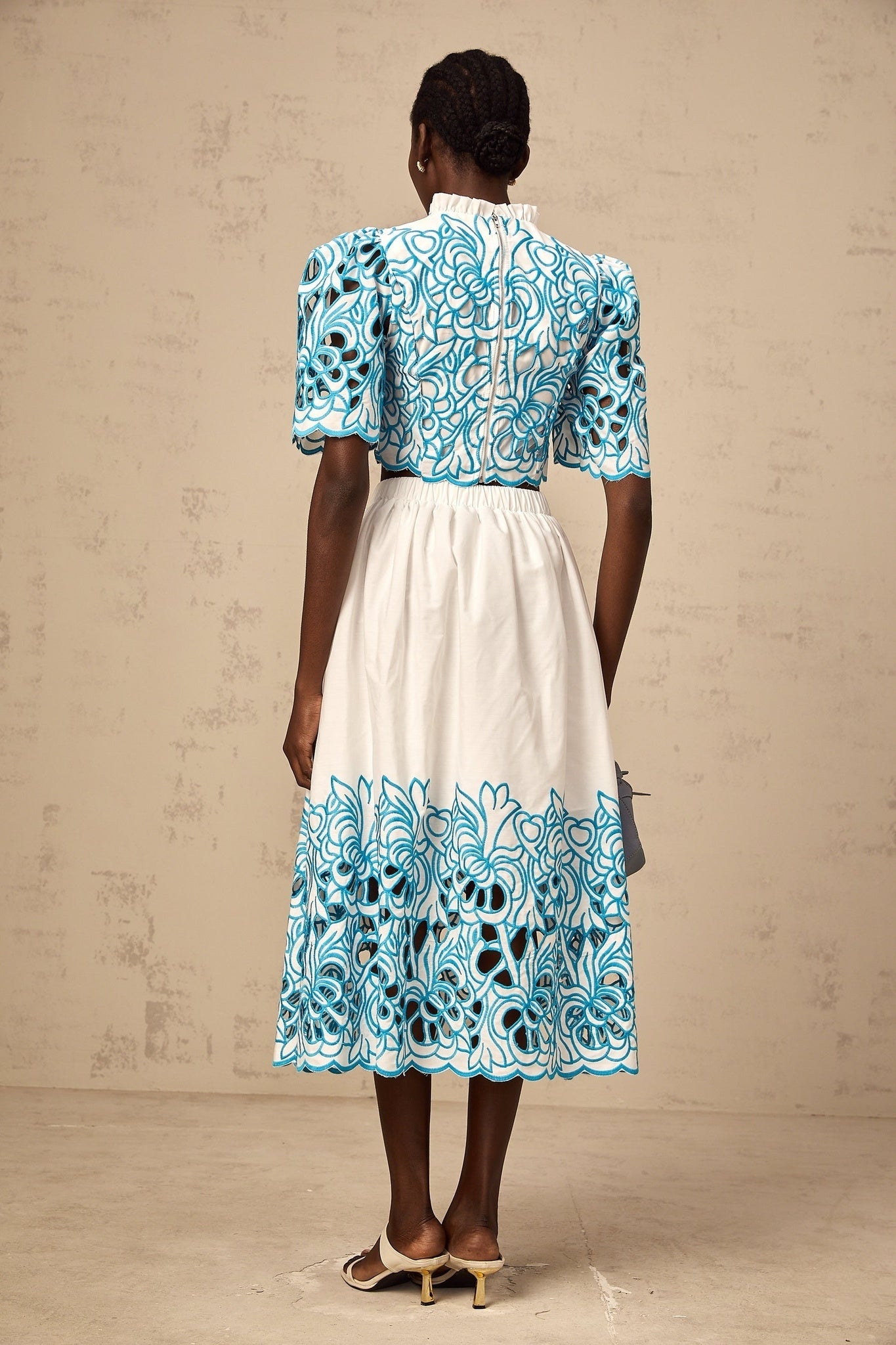 Aurore blue two piece outfit featuring cut out details and embroidery on both top and skirt