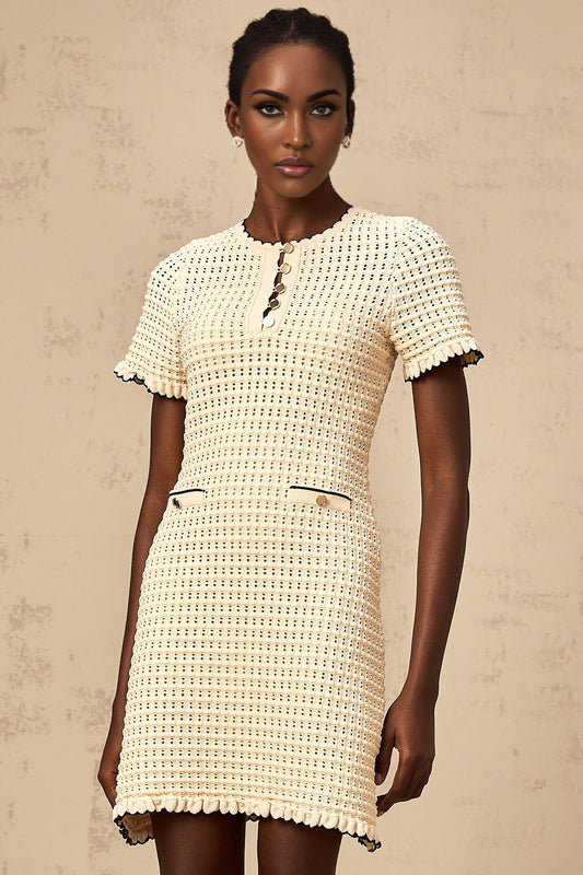 Beige knit mini dress with ruffled details and pointelle pattern