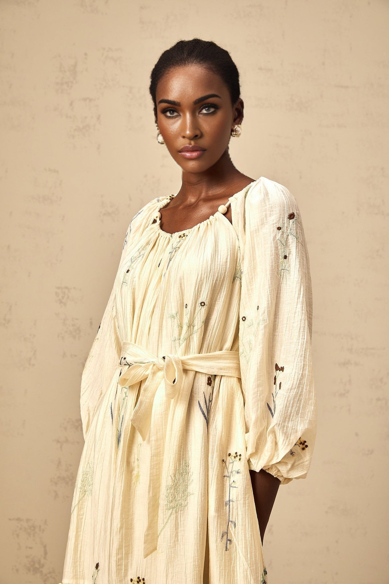 Beige midi dress with floral embroidery and beaded details featuring the Uranie design