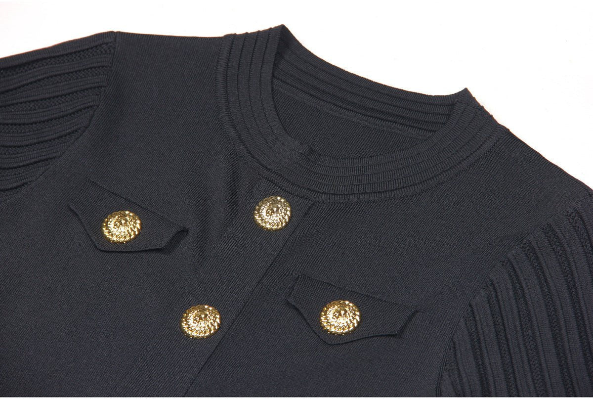 Black A-line dress with gold accents and pleated skirt