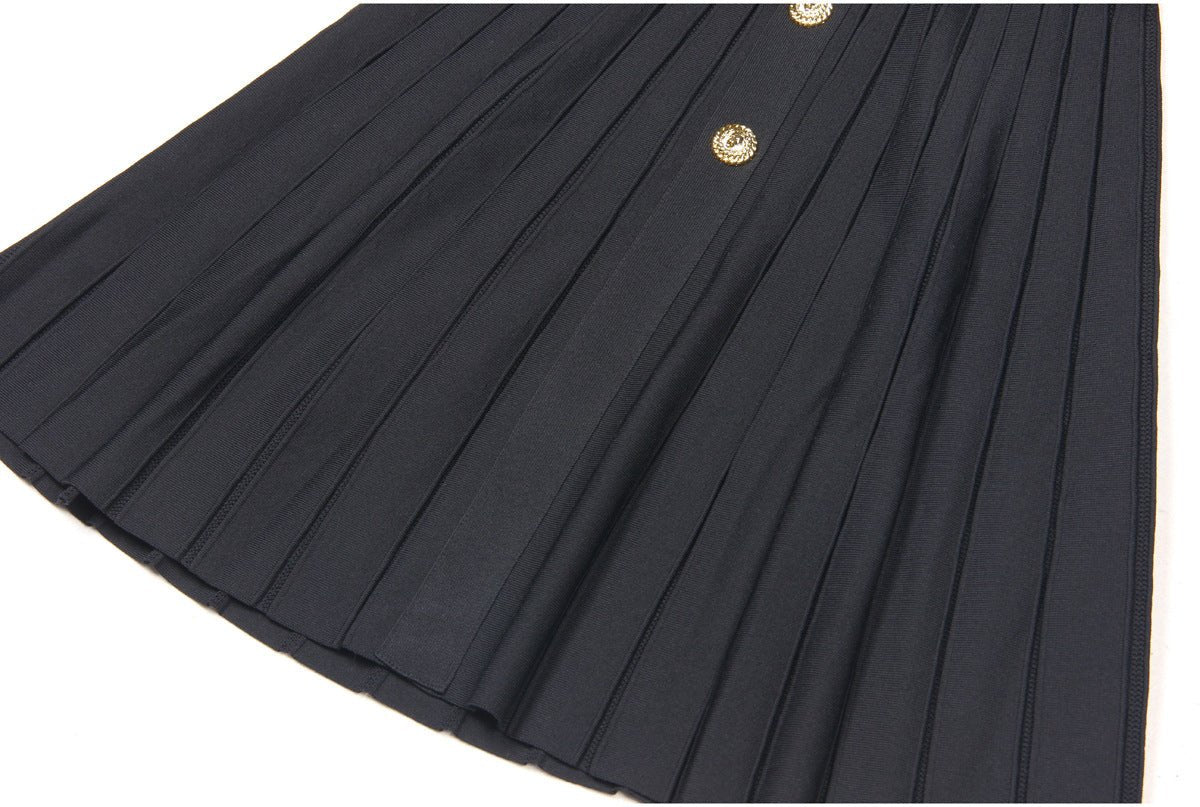 Black A-line dress with gold accents and pleated skirt