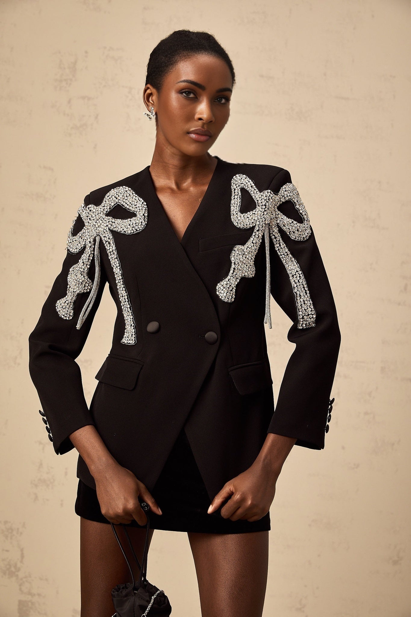 Black blazer with decorative bow motif embellishment