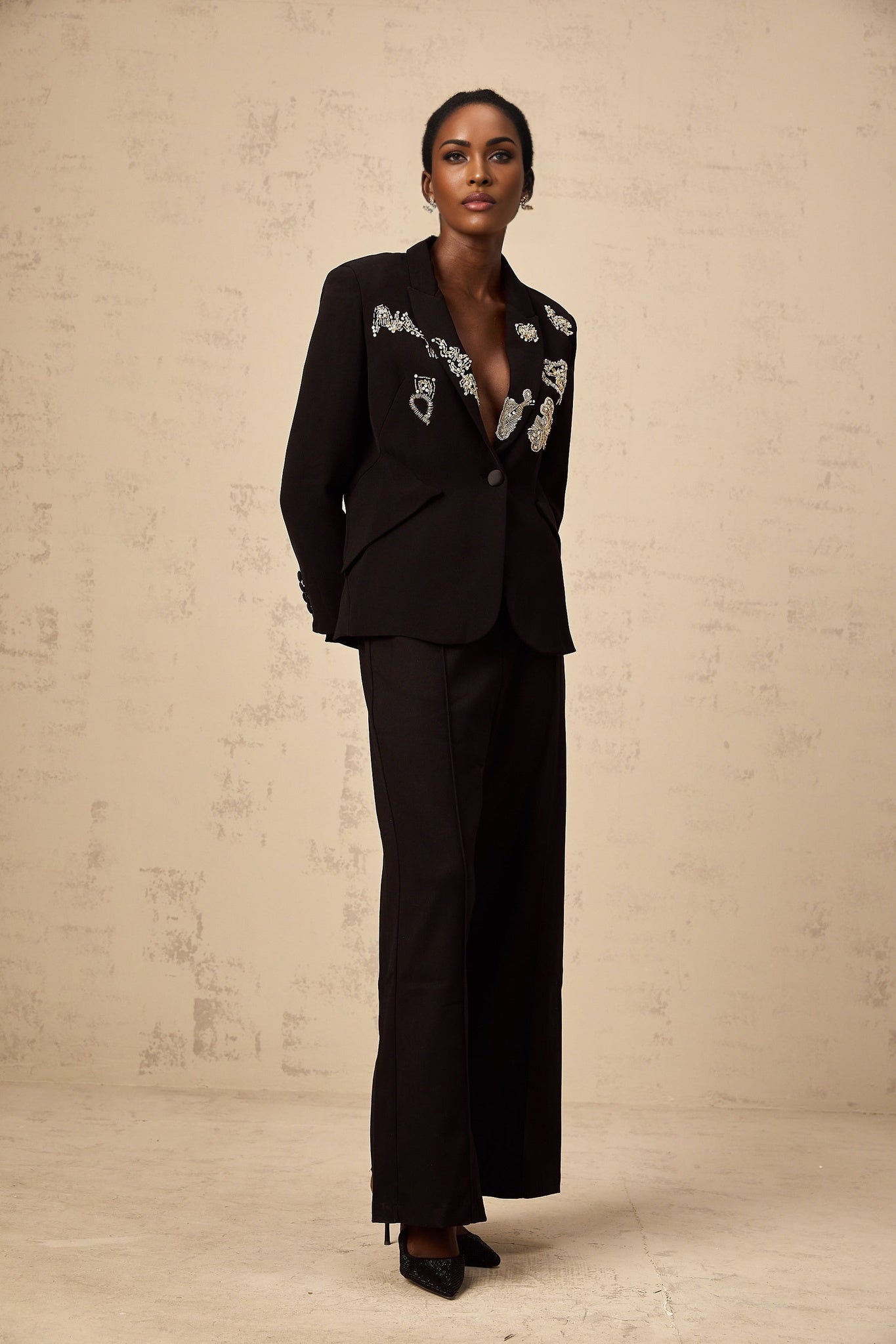 Black blazer with intricate bead embroidery detailing named Ximena