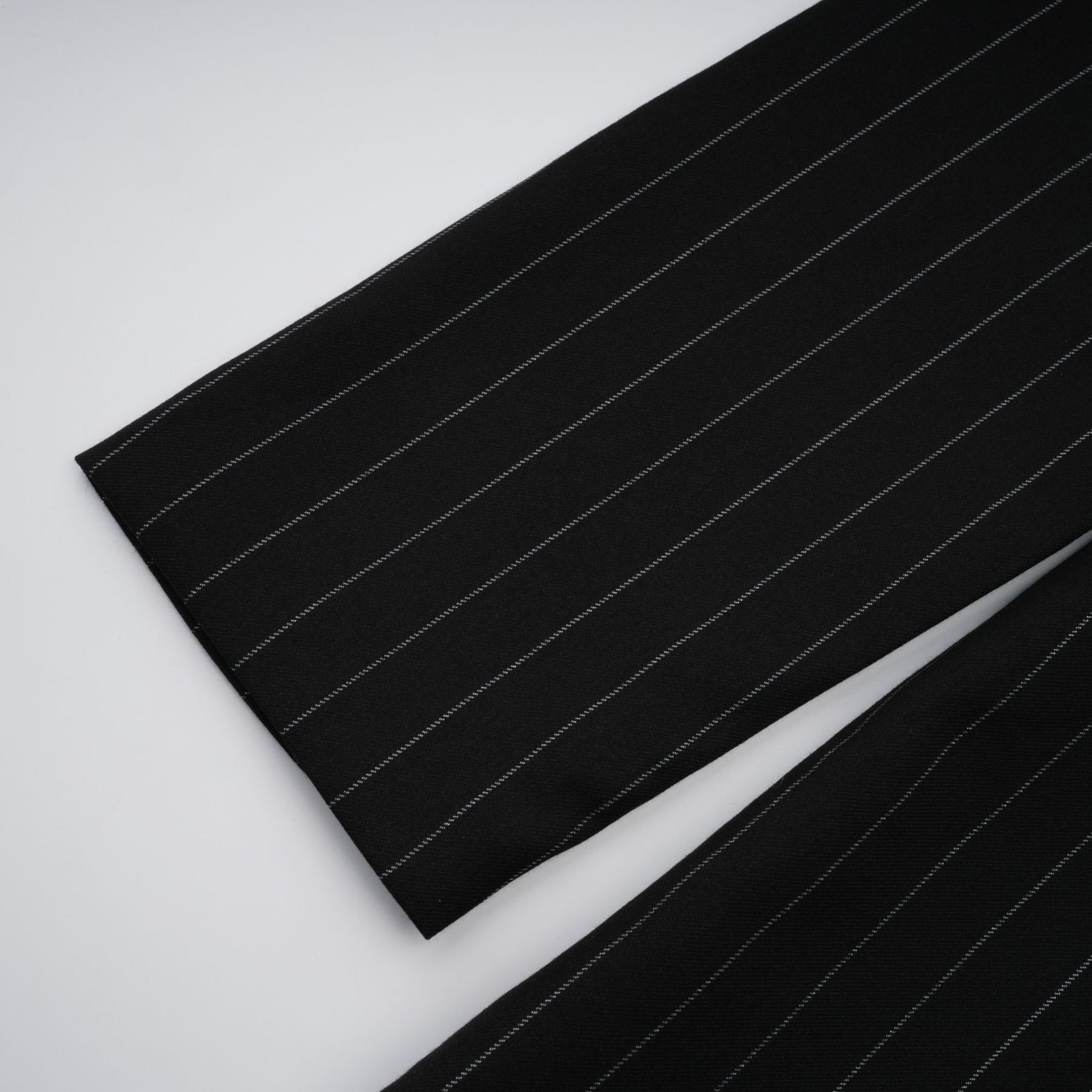 Black blazer with white stripes and open back design