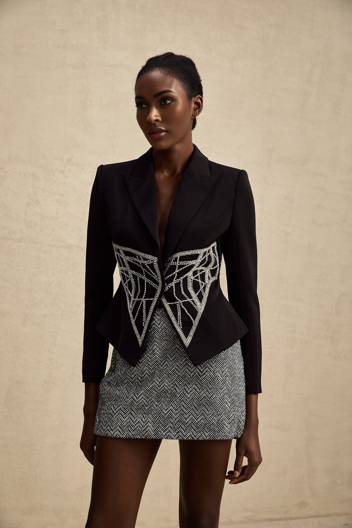 Black fitted jacket with embellished details and cinched waist named Genevieve