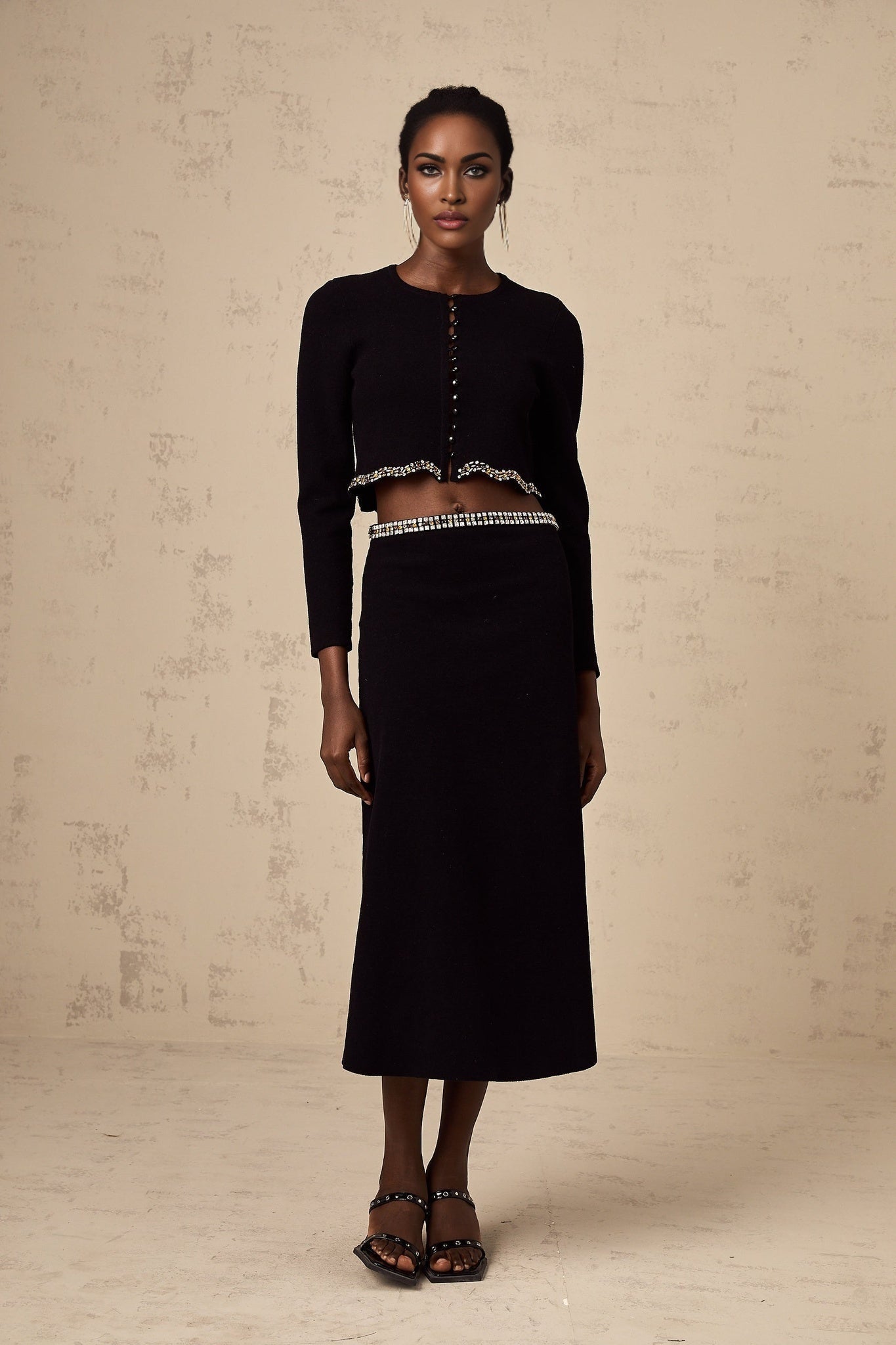 Black knitted cardigan and skirt set with embellishments named Magali