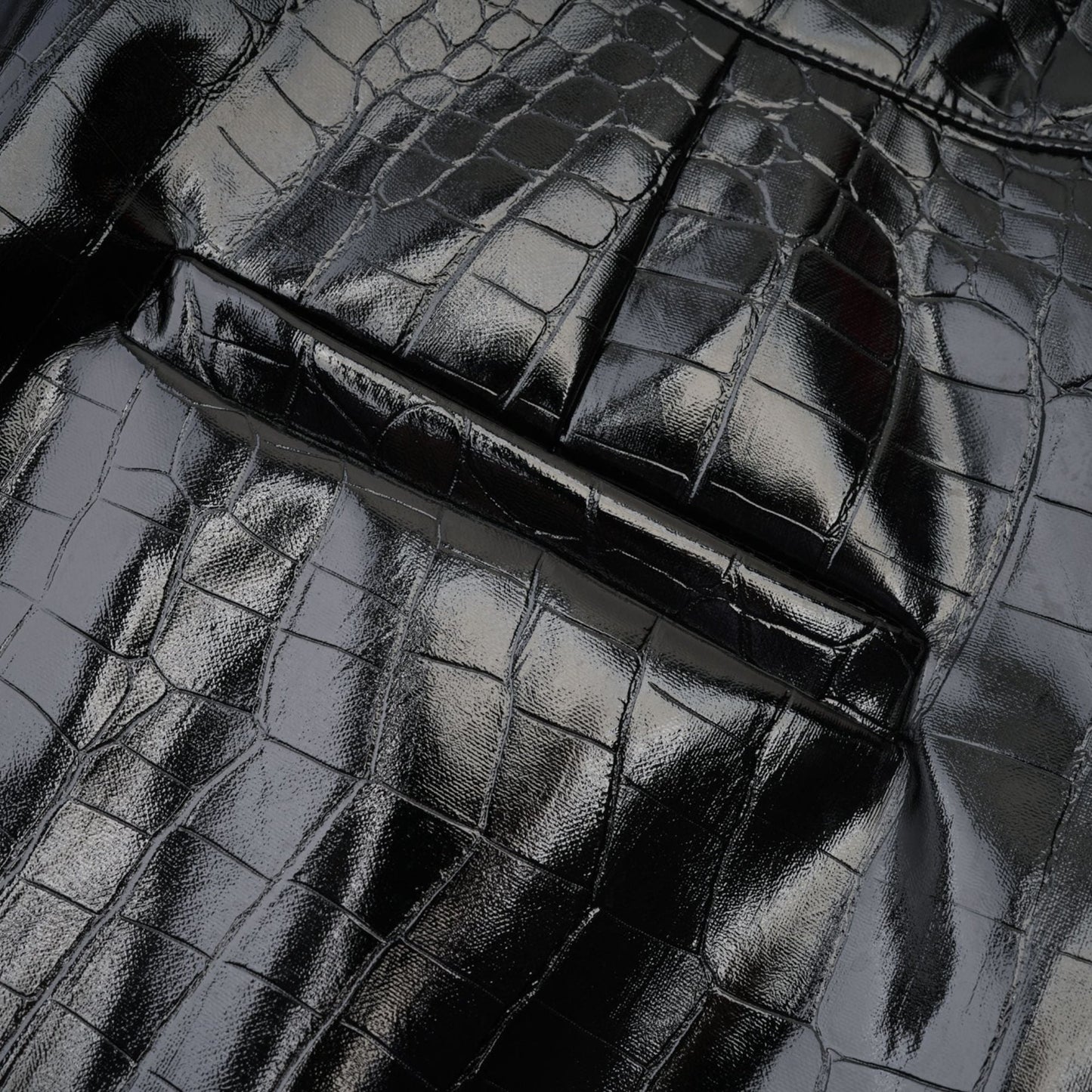 Genuine leatherlike jet black dress with professional pleats and a sleek buckle adornment