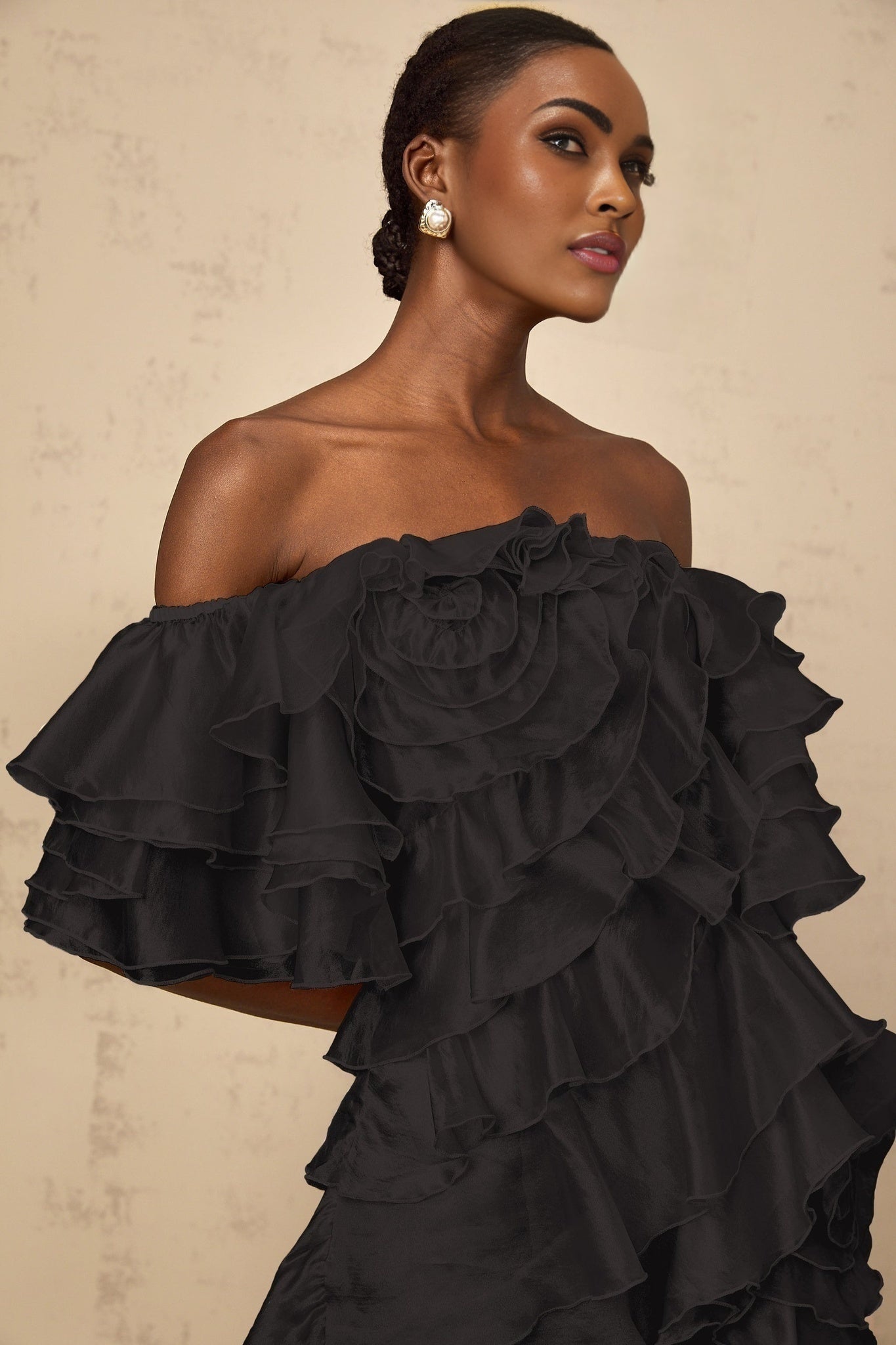 Black mini dress with asymmetric design and flounce detail in cerise color accent