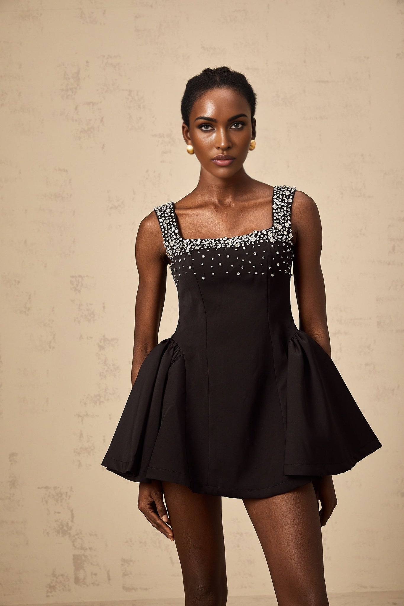 Black mini dress with flared skirt and crystal embellishments
