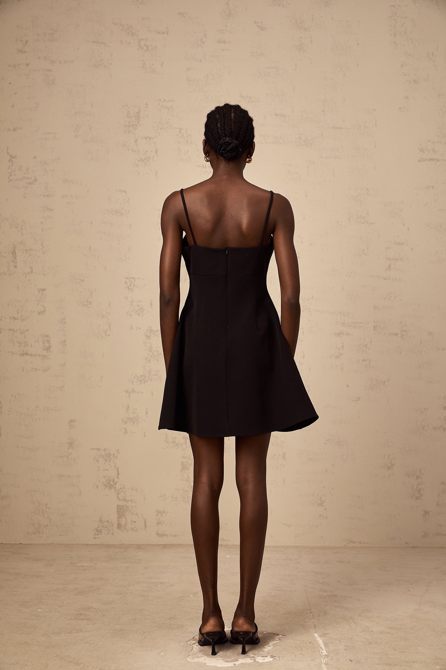 Black mini dress with flared skirt and rose applique details