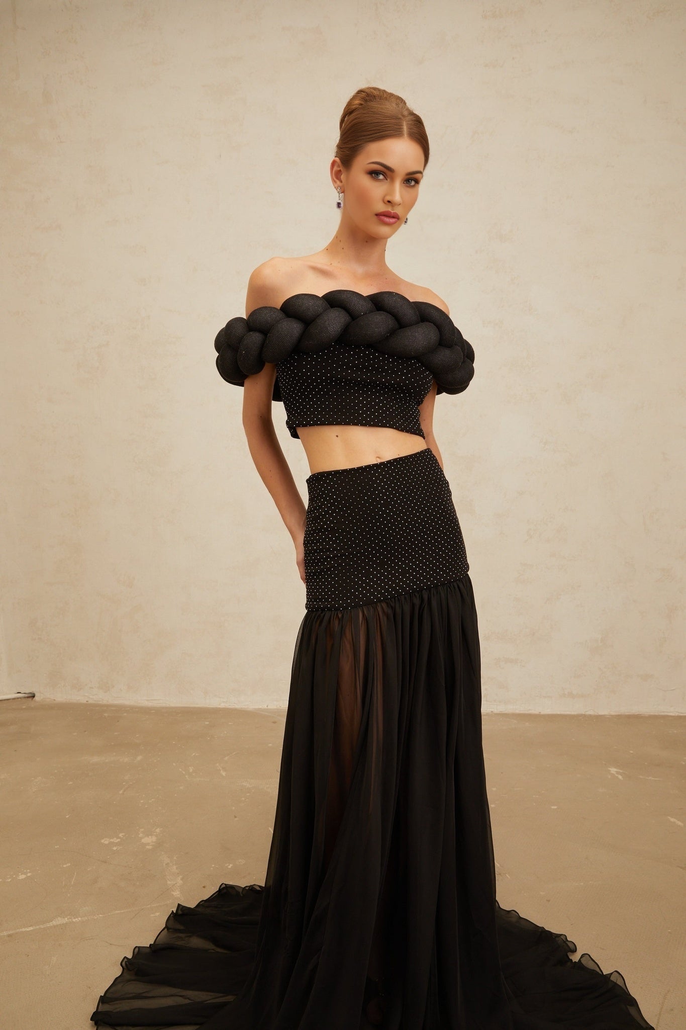 Black off the shoulder cropped top with braid detailing and rhinestone embellishment
