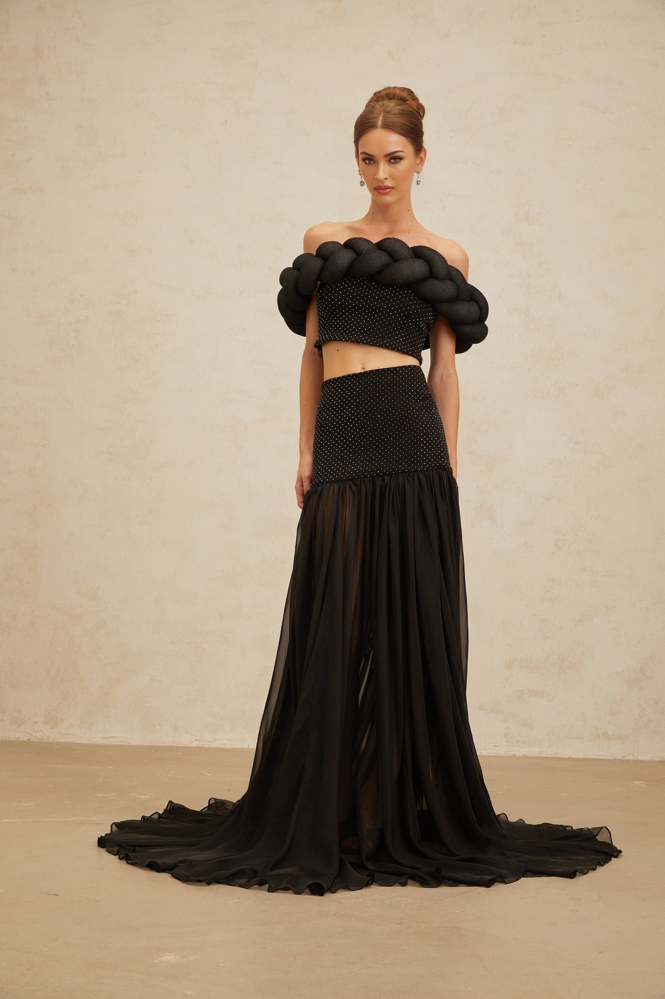 Black off the shoulder cropped top with braid detailing and rhinestone embellishment