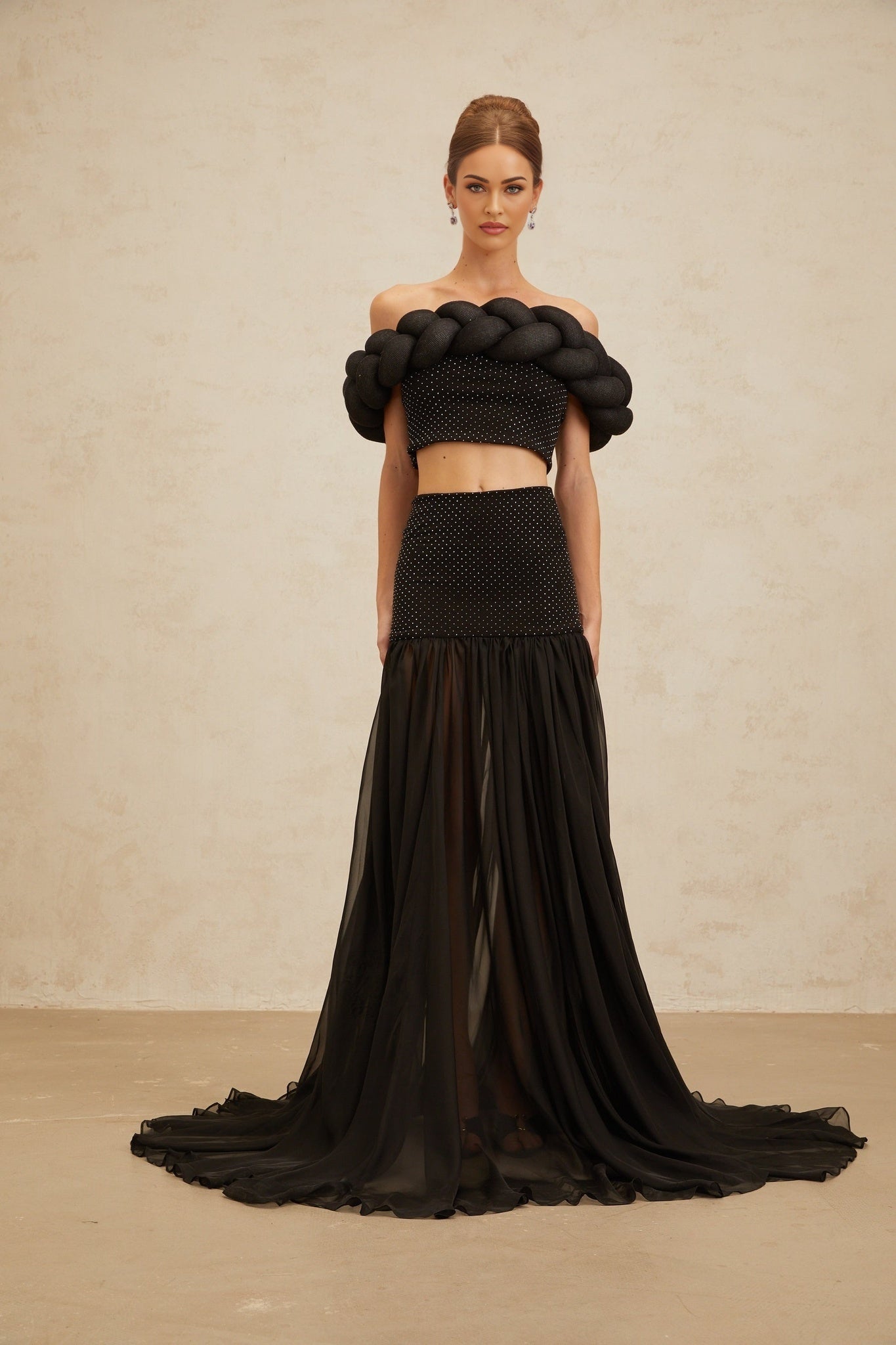 Black off the shoulder cropped top with braid detailing and rhinestone embellishment