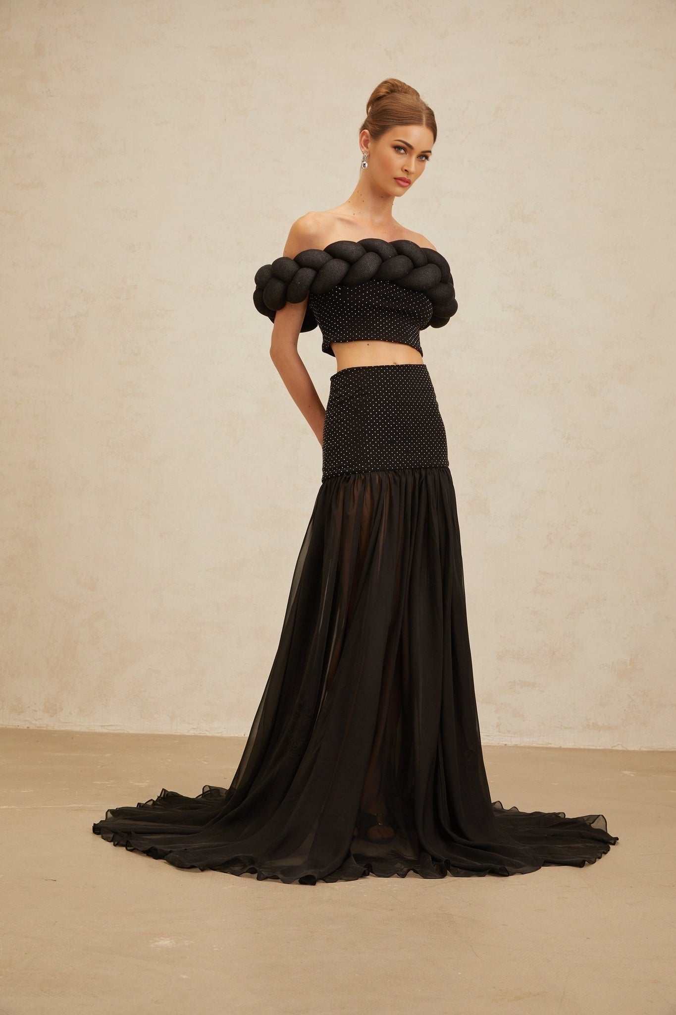 Black off the shoulder cropped top with braid detailing and rhinestone embellishment