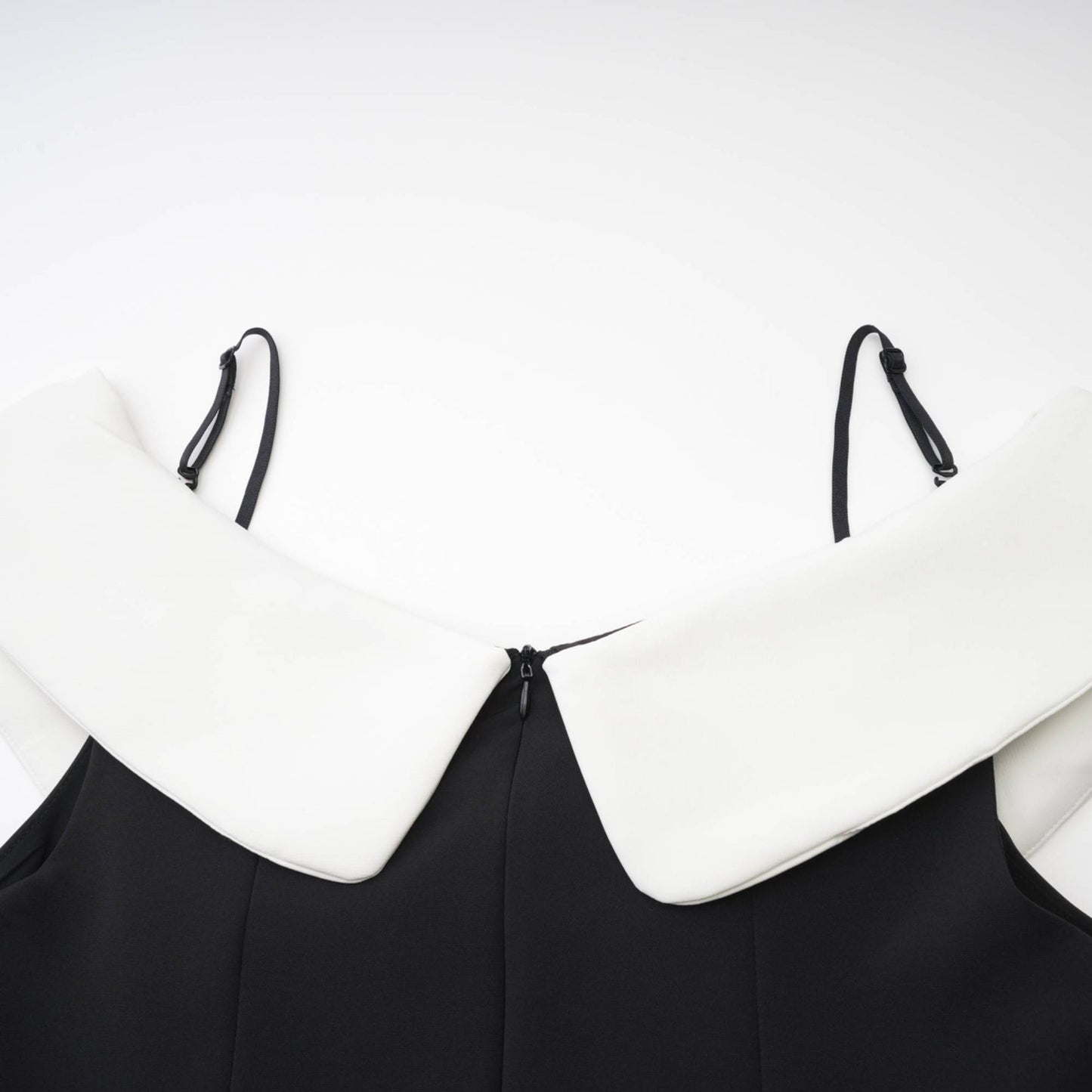 Black mini dress with reversable collar off the shoulder design contrast colors spaghetti straps pleated style front bowknot detailing and composed of 82% Cotton 18% Silk