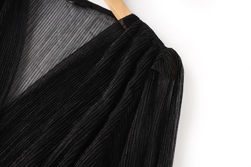 Black pleated maxi dress with V-neckline and sheer sleeves