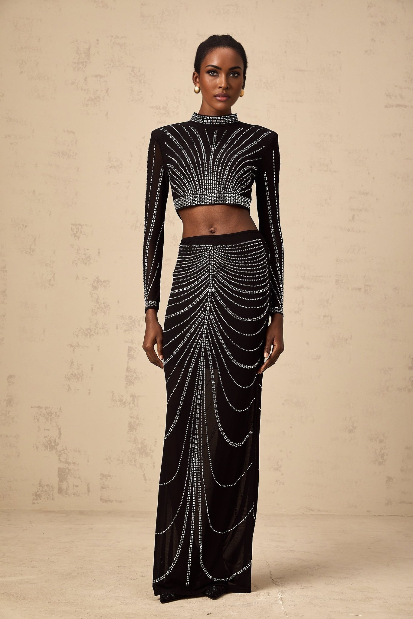 Black rhinestone mesh top and skirt set with matching pieces featuring sparkly embellishments on sheer fabric