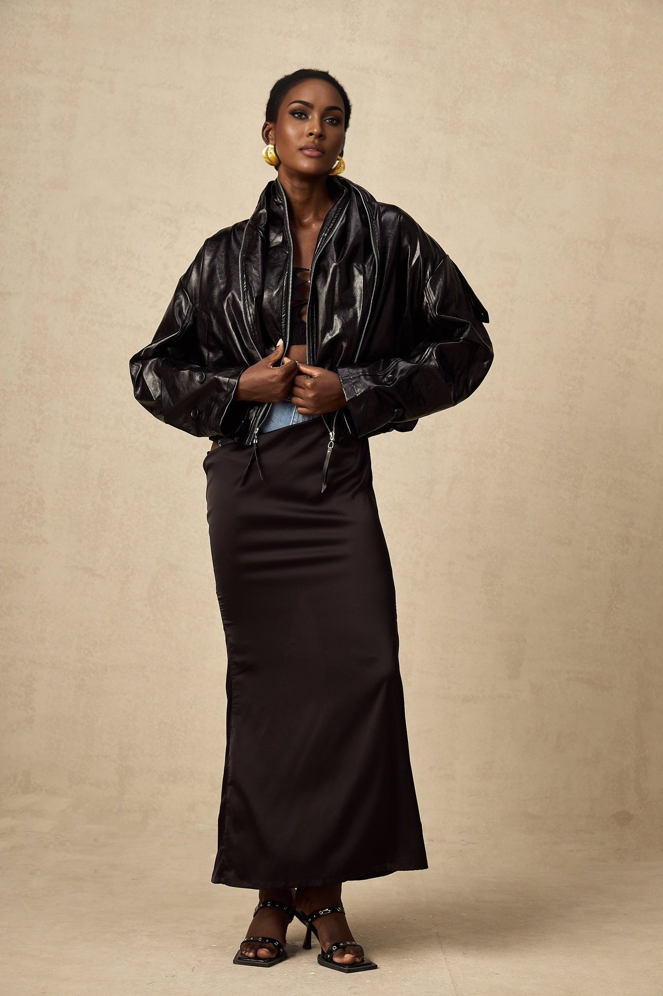 Black short quilted leather jacket with zipper closure and standup collar