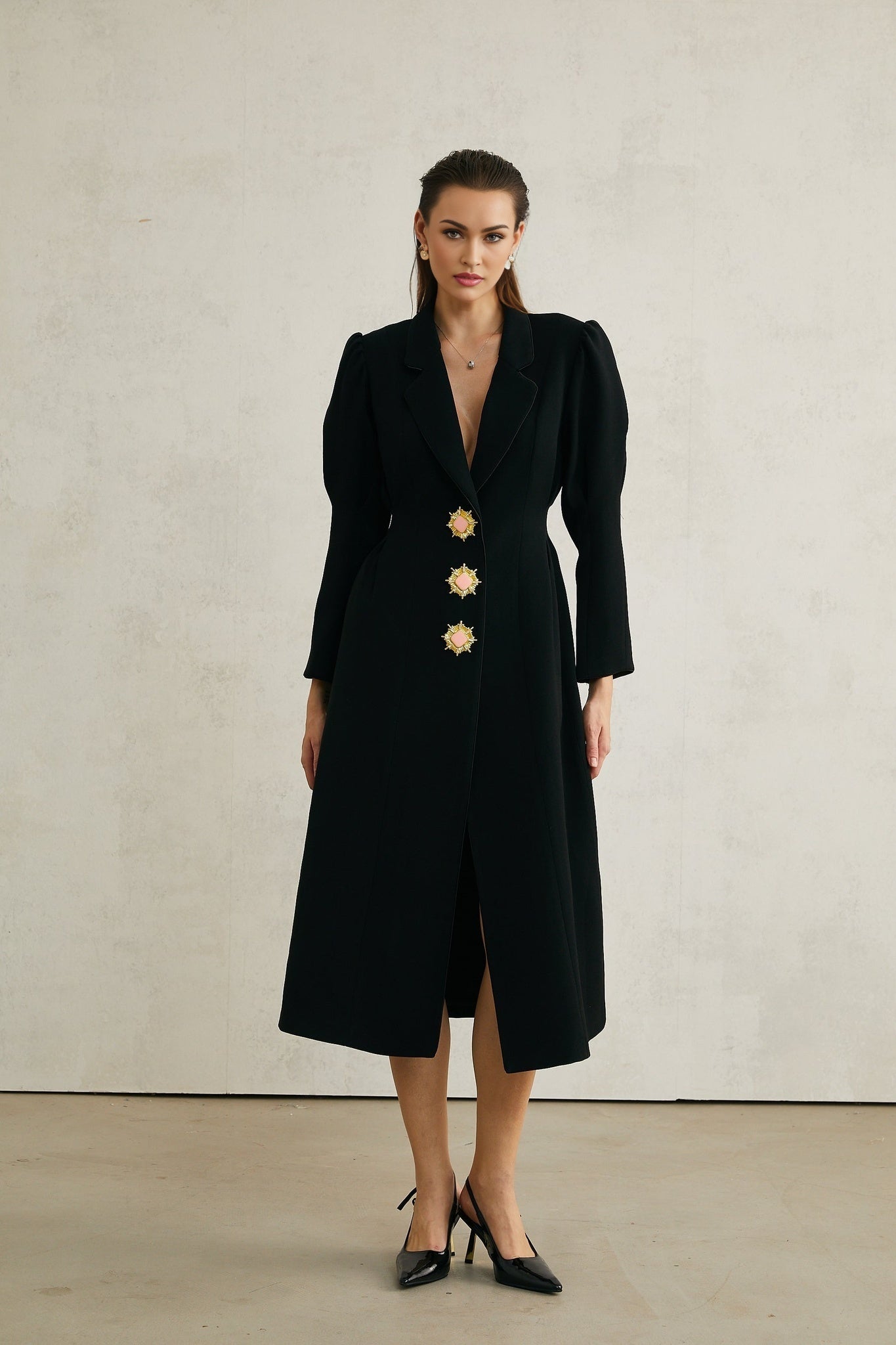 Black single breasted long coat by Aelle