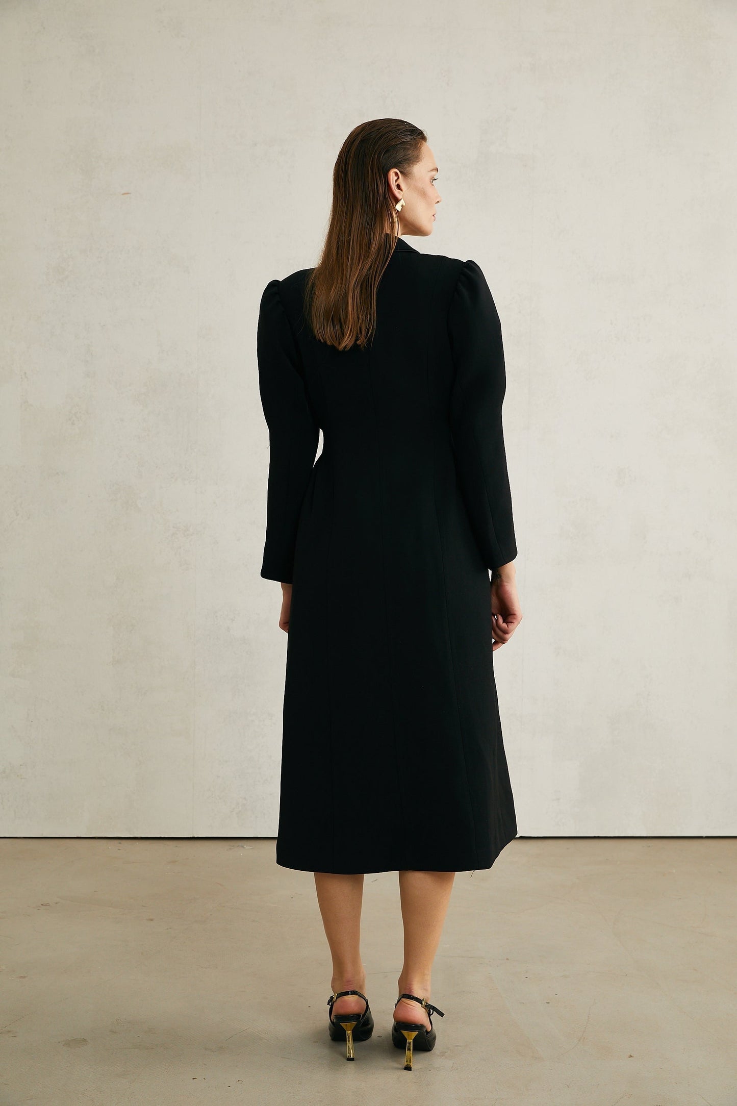 Black single breasted long coat by Aelle