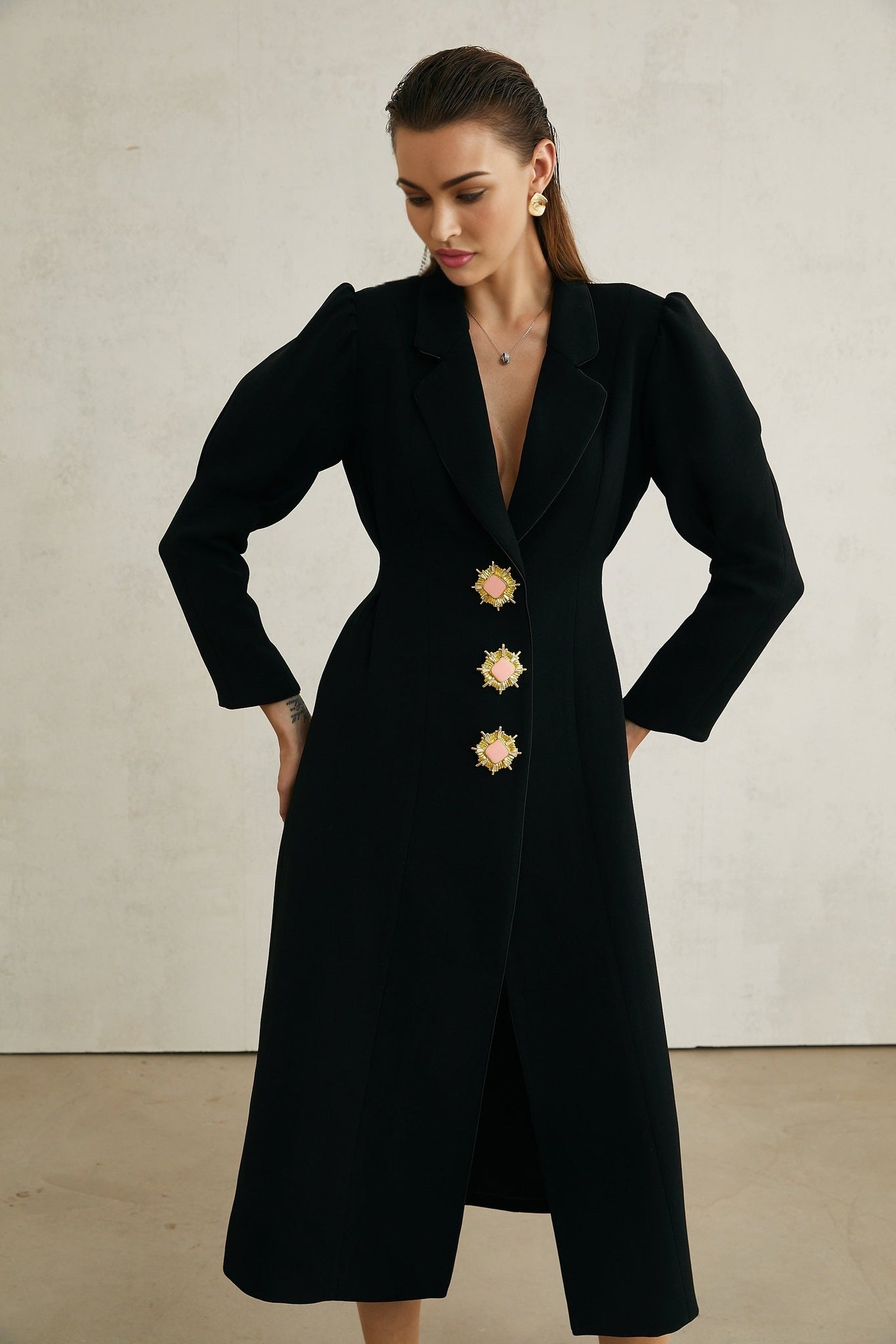Black single breasted long coat by Aelle