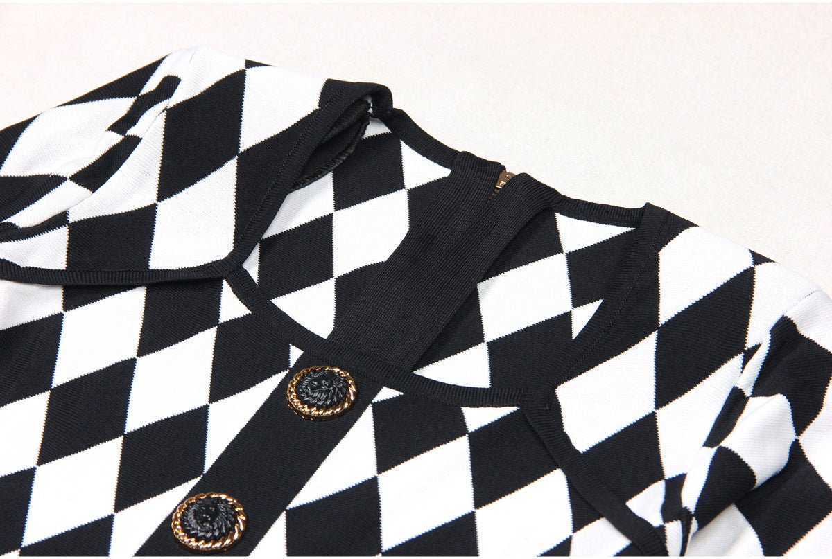 Black and white geometric harlequin pattern dress with gold decorative buttons