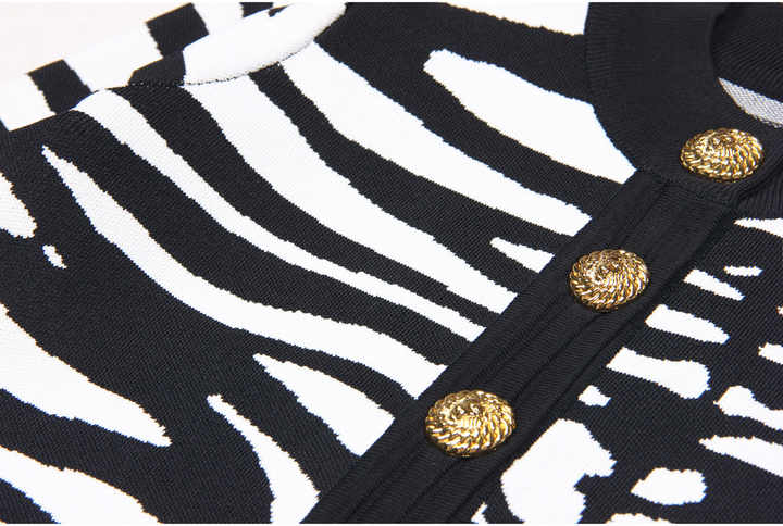 Black and white zebra print cropped cardigan with gold buttons