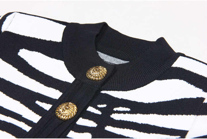 Black and white zebra print cropped sweater with gold buttons