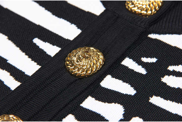 Black and white zebra print cropped sweater with gold buttons