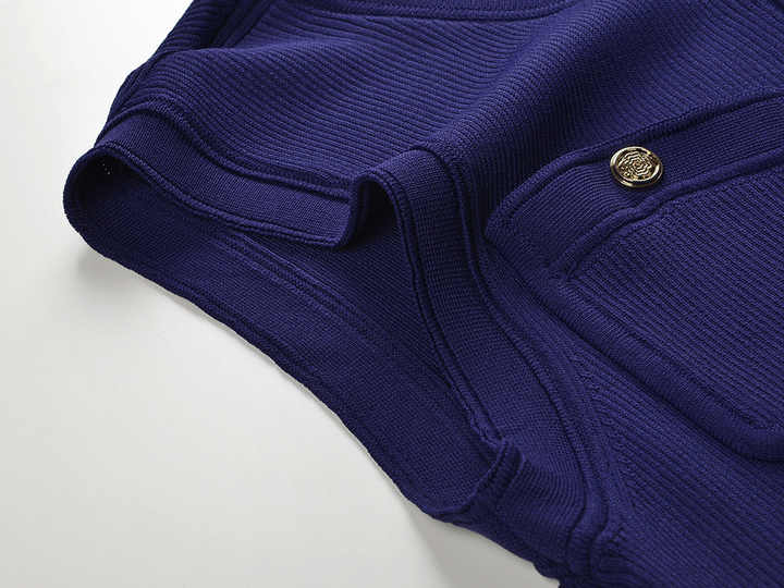 Blue knit pleated button-up top with tie-dye accents and decorative buttons