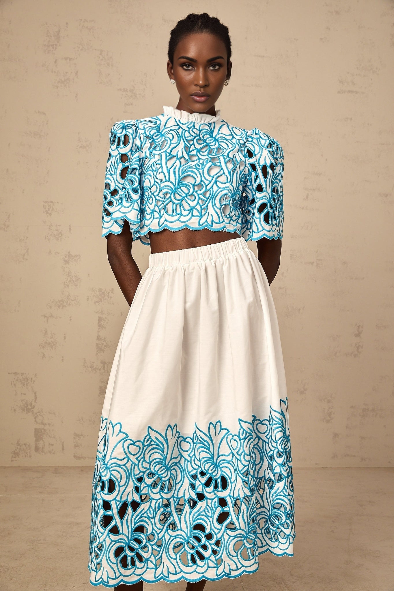 Blue matching set with embroidered top and skirt featuring cutout details