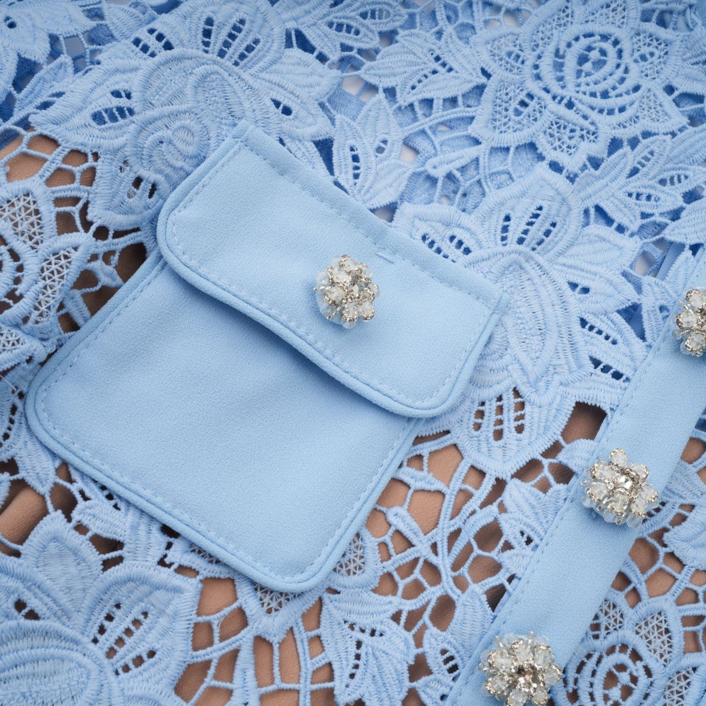 Blue mini dress with floral applique and ruffled lace details featuring a delicate floral pattern and feminine silhouette