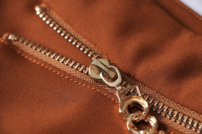 Brown high-waisted flared-leg pants with gold chain embellishment