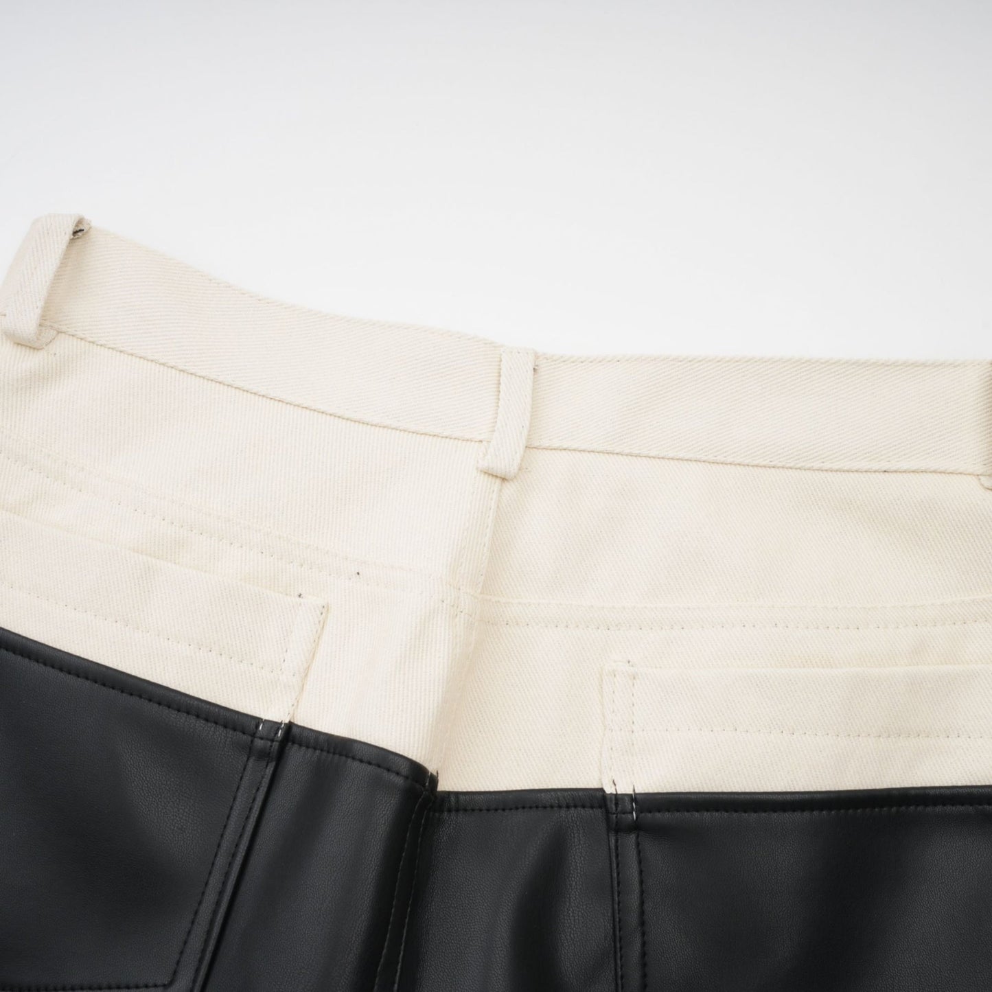 Brown leather trousers with contrasting color panels on the sides