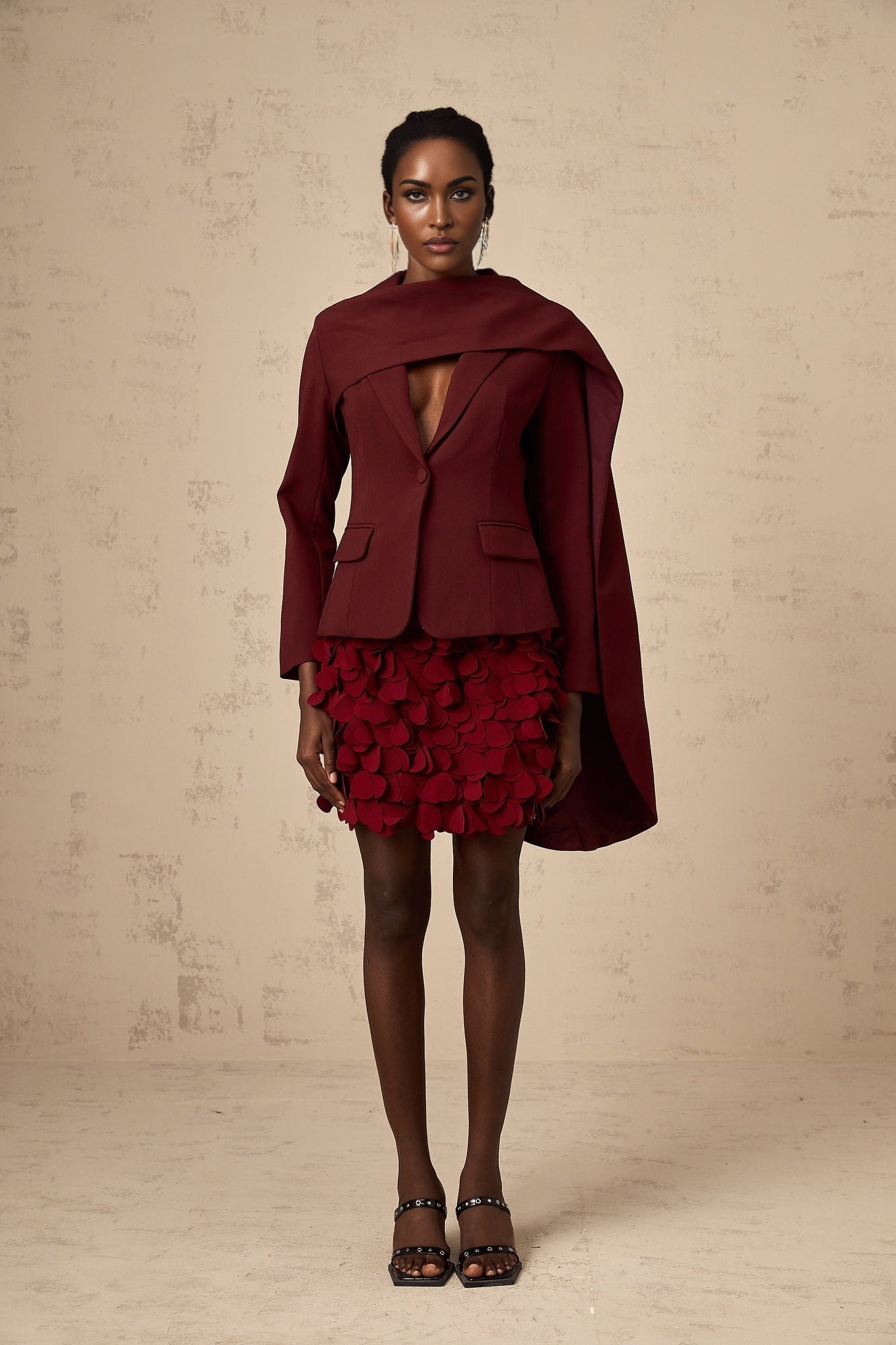 Burgundy colored jacket with shawl collar and draped details called Coralie