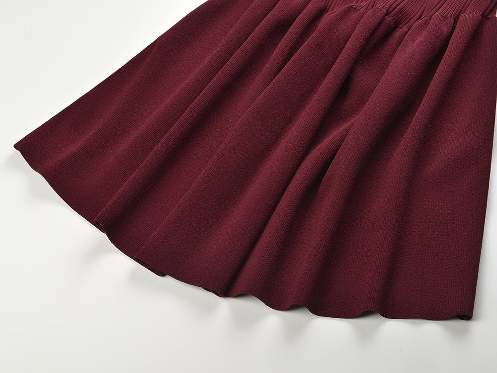 Burgundy fitted silhouette with flare at bottom ribbed knit cardigan with button details tailored fit accentuating curves versatile for layering or standalone ideal for fall or winter wear soft stretchy fabric notched collar and flared sleeves suitable for formal or semi-formal events modern and chic with vintage appeal