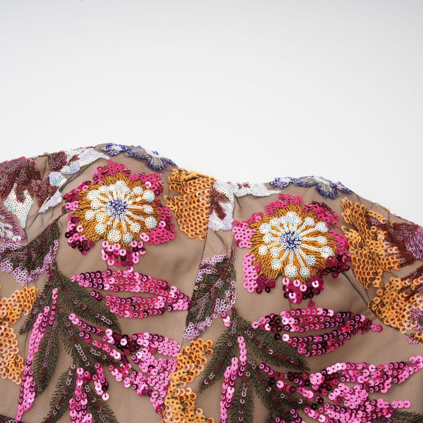 Colorful midi dress with sequin embellishments and floral embroidery by Therese featuring vibrant patterns and shimmering details