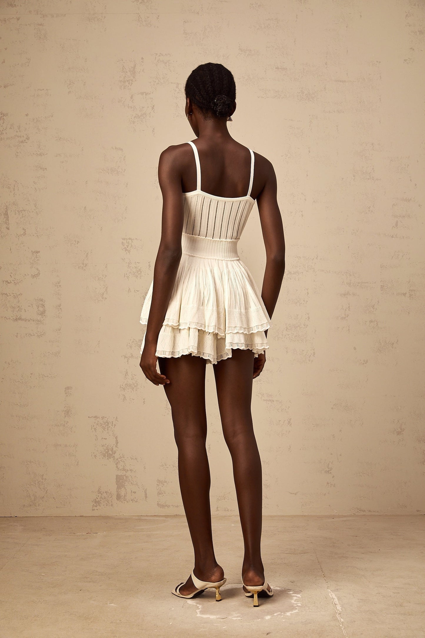 Creamwhite matching set featuring a shirred crochetknit top and culottes with textured pattern