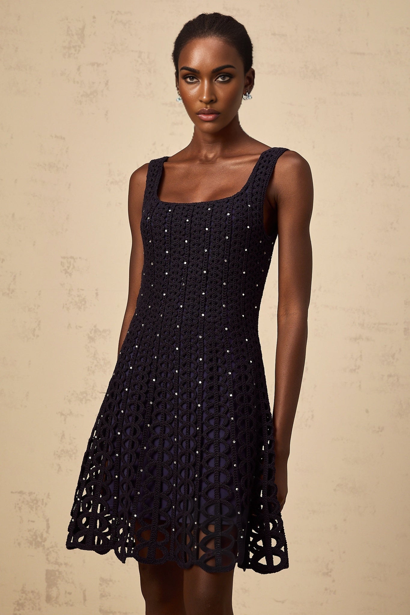 Edelie dark blue mini dress with embellished details and crochet knit pattern featuring cutout design