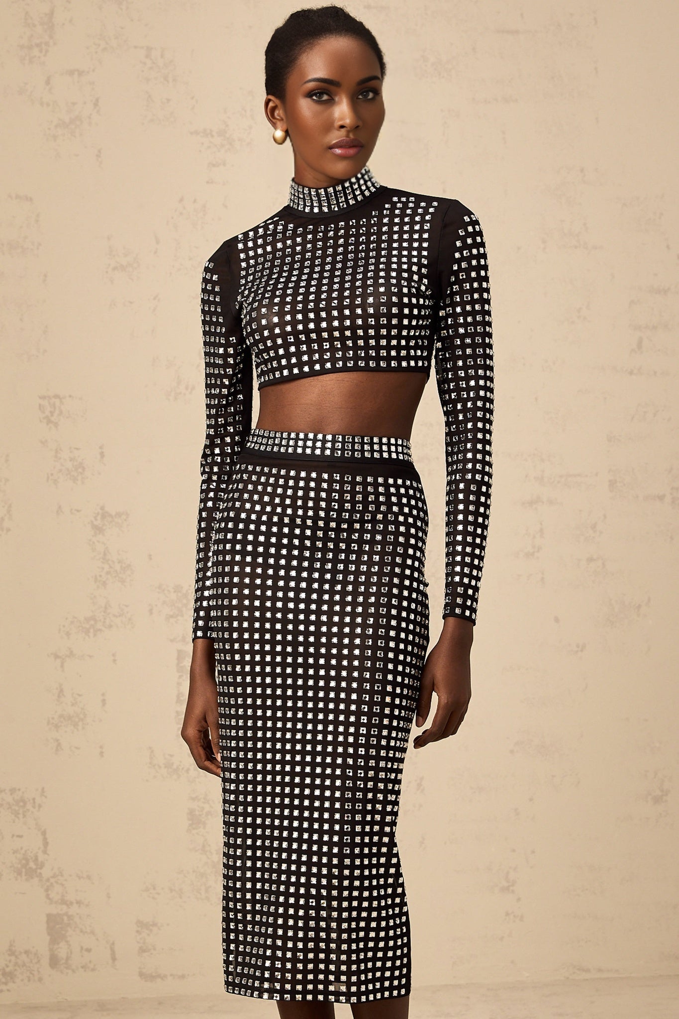 Elegant black matching set featuring a mesh top and skirt adorned with sparkling rhinestones Vera brand womens formal wear