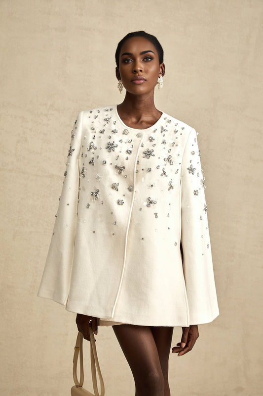 Elegant white jacket with capelike design and sparkly embellishments on shoulders and collar
