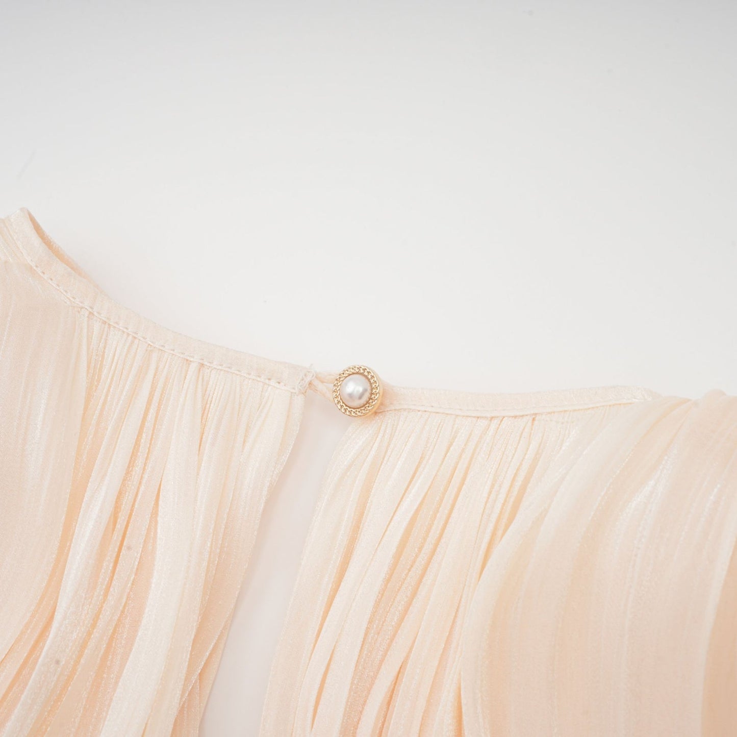 Eugenie fully pleated ruffled mini dress in neutral color short length dress with allover pleats and ruffled details