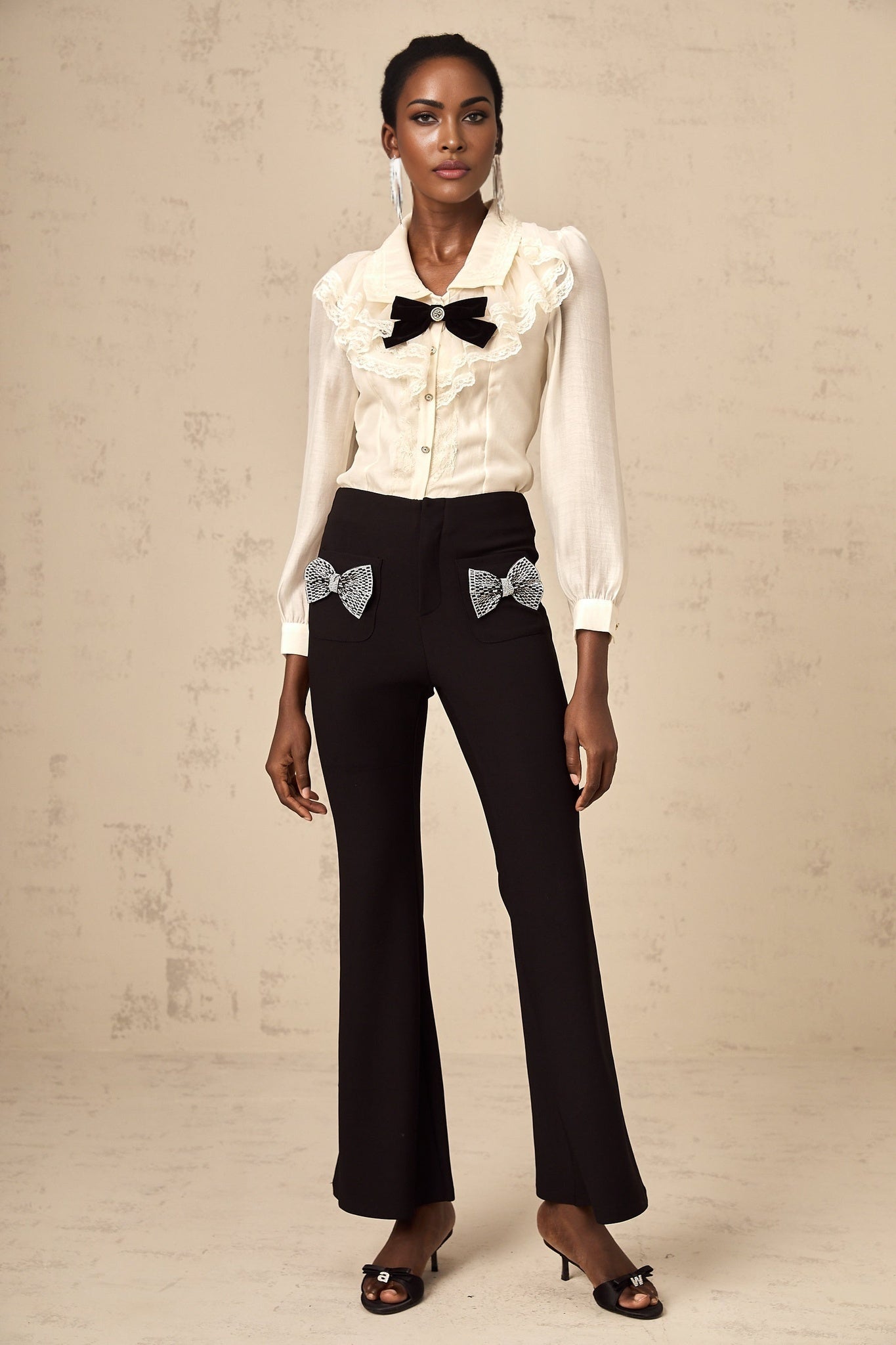 Flared trousers with a decorative bow embellishment named Gelsomina