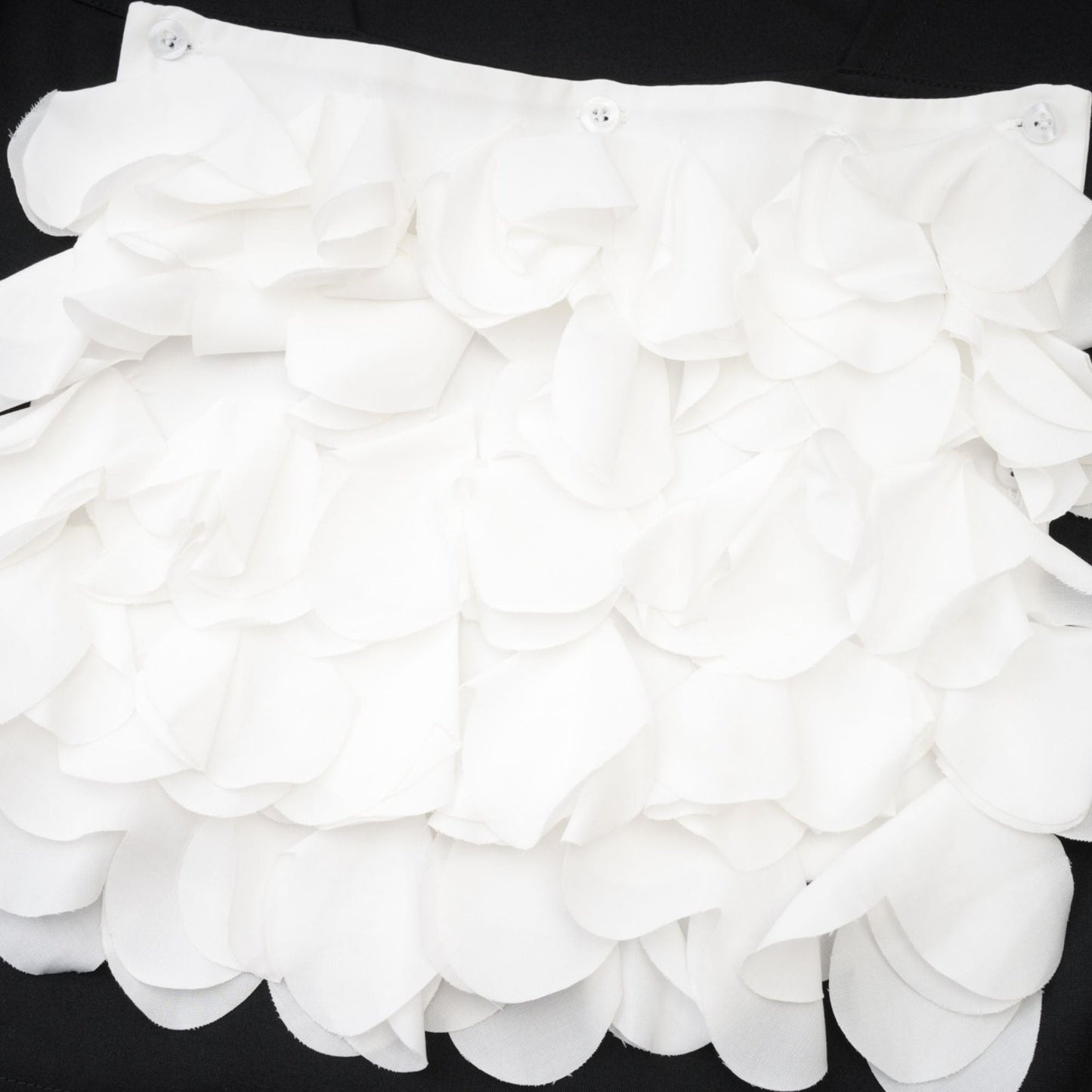 Floral patterned sleeveless top with faux flower embellishments on white background